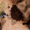 Coffee,Beans,,World,Map,And,Compass,For,Travel,,Top,View