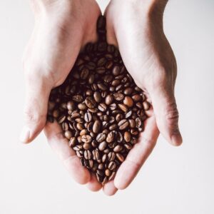 hand holding coffee beans